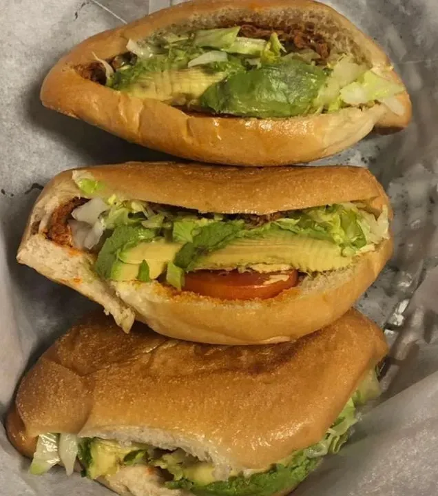Three tortas from Southmost Tortas filled with meat, avocado and lettuce